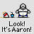 Pixel art animation of a white-shirted character with blue pants and a red-and-white object, displaying sequential pose changes while text reads 'Look! It's Aaron!' below.
