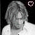 A 50x50 pixel animated contact sheet showing two frames of a grayscale cartoon character with short hair and a white shirt, each frame featuring a heart symbol in the top-right corner that changes from hollow to filled.