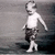 Black-and-white animation of a child walking left to right across a textured background, wearing shorts and no shirt.