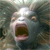 Pixelated image of a fish with wide eyes and an open mouth against a blurred background.