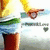 A person in yellow shirt and blue shorts holds a brown object with heart-shaped cutout, standing on white background with "Peace&Love" text below.