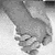 A 2x2 contact sheet of a black-and-white animated icon showing two hands holding, with partial text overlays on the right and bottom frames.