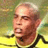 Pixelated static image of a person in sports attire with yellow and green background elements.