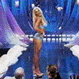 Animated sequence of a woman in a bikini performing a dance routine on a stage with blue and purple lighting.