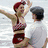 Animated sequence showing a woman in red-and-white checkered bikini and maroon cap dancing with a man in white shirt and gray flat cap near water, then transitioning to people on a boat.