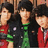Three individuals in red and green clothing stand against a pink background with blue text reading "The Jonas Brothers" and "are so cute!!"