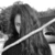 Black-and-white pixelated image of a figure with long hair holding a glowing sword-like object diagonally across the frame.