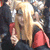 A pixelated static image shows a figure with long light brown hair, red clothing, and a bright white light effect behind the head against a dark background.