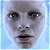 Pixelated close-up of a human face with light skin tone, dark eyes, and dark lips against a light blue background.