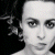 Static image of a person with dark hair against black background, next to green text reading "Original Icons .com" in pixelated font.