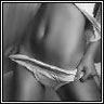 Black-and-white close-up of a person's lower torso and legs wearing striped underwear, with one hand visible near the waistband.