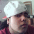 A person wearing a white cap and red shirt appears in four with slight variations in head position and facial expression