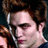 Pixelated close-up of a person with dark hair and light skin, wearing a white shirt against a dark background.