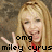 A pixelated image of a person with long blonde hair making peace signs, wearing red clothing against a brown textured background.