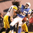 Pixelated animated icon shows two figures in yellow and blue outfits with white accents, one figure's head turning left to right across frames.