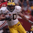 Pixelated image of a football player in white and yellow uniform with number 0, next to blue background with yellow text reading DO THA HEISMAN ON DAT HO.