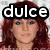 A pixelated image of a person with long red hair, showing three variations of overlaid text: 'dulce', 'te', and 'amo' in white letters on black backgrounds.