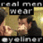 Pixelated image of a man with short dark hair wearing a black shirt, positioned between two golden rectangular shapes under text reading 'real men wear' and 'eyeliner'.
