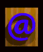 Animated sequence of a blue @ symbol and 'EMAIL ME' text on wooden against black background, showing rotation and perspective changes