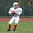 A pixelated image of a football player in white uniform holding a ball, with red text blocks on red and gray backgrounds.