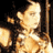 Pixelated static image of a person in motion with warm lighting and dark background, likely from a historical movie or performance context.