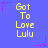 Blue background with yellow text reading 'Got To Love Lulu' repeated in a pattern, surrounded by pink star and dot decorations