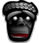 Pixelated grayscale icon of a stylized face with glowing eyes and red mouth, appearing as a cartoonish mask or mascot against gray background.