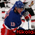 A hockey player in a blue jersey with red and white trim holds a stick, shown across three views where text below changes from 'Nikolai' to 'Zherdev'.
