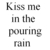 Two side-by-side animated frames of a text-based buddy icon showing the phrase "Kiss me in the pouring rain" with one frame having blue-tinted text.