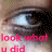 A pixelated close-up of a human eye with light blue iris and black pupil, overlaid by bold pink text reading 'look what u did' on a blurred background.