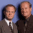 Two men in formal attire stand side-by-side against a blue background on the left, while green text reading "Original Icons .com" appears on a dark green background on the right.