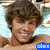 A person with curly brown hair lies on a light blue patterned surface, smiling in three views where text overlays change position and color.