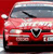 A static pixelated image of a red car with a silver roof, front grille, and headlights, set against a solid red background.