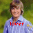 Pixelated image of a person with light brown hair wearing a light blue shirt with dark blue collar, standing against green background with red text 'lover' overlaid.