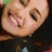 A static image with a cyan background, featuring a pixelated photo of a smiling person on the left and orange pixelated text on the right.