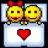 Two yellow pixelated faces with green eyes and brown mouths lie on white pillows, one wearing a red bow, with a red heart below them on a white background.