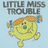 Yellow cartoon character with orange pigtails and blue hair ties on light blue background, text "LITTLE MISS TROUBLE" above.