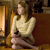 A pixelated figure in a light-colored long-sleeve top and dark skirt sits on a brown chair, facing left with a neutral expression.