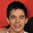 A person with short dark hair appears in four against a red background, showing facial expression changes and text overlays
