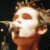 Pixelated image of a person with light brown hair holding a microphone, next to white text on black background reading 'Bryan of Phat Chance'.