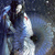 Pixelated static image of two figures in blue and white attire against a dark background with scattered light spots.