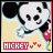 Pixelated cartoon character face with large black ears, white muzzle, and red bow tie on light beige background.