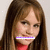 A static pixelated image of a person with long brown hair wearing a red top, with a purple and white horizontal bar across the mouth area.