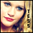 Pixelated close-up of a person with light skin, blue eyes, and red lips, with vertical text reading TESS on the right side.