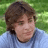 A pixelated image divided into four quadrants with green and gray sections containing text and a person in a blue shirt.