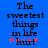 Blue background with black pixelated text reading 'The sweetest things in life' and a pink-and-purple heart symbol below the word 'hurt'.