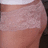 A pixelated close-up of a light-skinned human torso with visible shoulder and upper chest area, cropped tightly against a dark background.