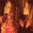 A 48x48 pixel animated contact sheet showing two frames of a cartoon-style icon with two women on the left and green text on the right against a dark background.