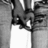 Black-and-white image of a person's lower body in jeans and white shoes with red text reading "I Love Jared" on a black background.