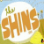 Pixelated static image featuring large orange text "THE SHINS" on a white circular background with green cactus and yellow sun elements against blue sky and grassy field.